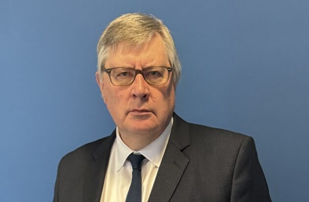 Headshot of Roger Hirst MBE, taken in October 2025