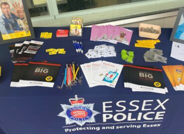 Picture of a display stall with fraud prevention advice leaflets and merchandise